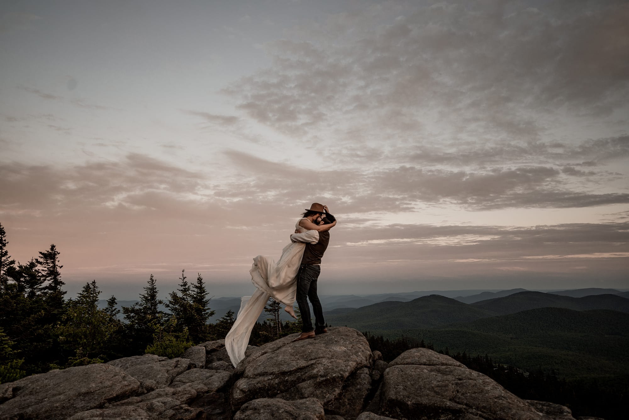 Getting married on top of a mountain, adventurous elopement photography, groom lifting up bride